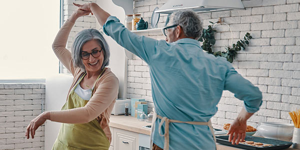 Older couple dancing in their kitchen